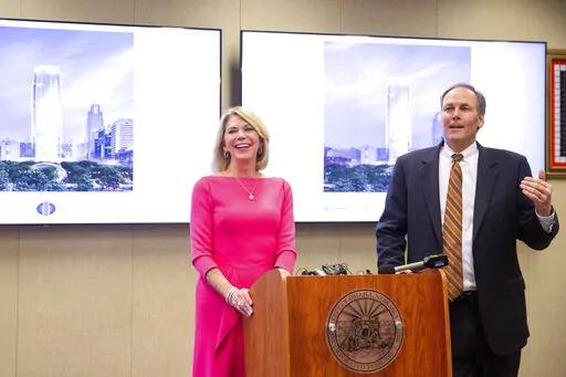 Omaha Mayor Jean Stothert, left, and Mutual of Omaha CEO James Blackledge announce plans for a new Mutual of Omaha headquarters skyscraper on the site of the current downtown library, Wednesday, Jan. 26, 2022. Many companies are recommitting to office space and moving forward with major projects because they believe working in person is better for collaboration and training younger employees. The plans also include building a three-mile streetcar system that would run from the riverfront to Nebr