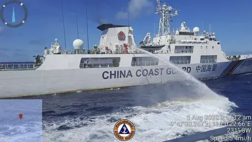 In this handout photo provided by the Philippine Coast Guard, a Chinese coast guard ship uses water canons on a Philippine Coast Guard ship near the Philippine-occupied Second Thomas Shoal, South China Sea as they blocked it's path during a re-supply mission on Aug. 5, 2023. (Philippine Coast Guard via AP, File)