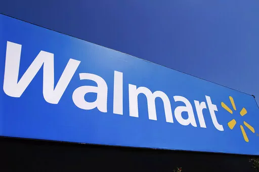 The Walmart logo is displayed on a store in Springfield, Ill., May 16, 2011. Walmart filed a motion on Monday, Aug. 29, 2022, to dismiss a lawsuit by the Federal Trade Commission in June that accused the nation's largest retailer of allowing its money transfer services to be used by scam artists, calling it an “egregious instance of agency overreach.” (AP Photo/Seth Perlman, File)