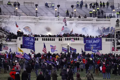 Violent insurrectionists loyal to President Donald Trump storm the U.S. Capitol, Jan. 6, 2021, in Washington. An Arkansas truck driver who beat a police officer with a flagpole attached to an American flag during the U.S. Capitol riot was sentenced Monday, July 24, 2023, to more than four years in prison. Peter Francis Stager struck the Metropolitan Police Department officer with his flagpole at least three times as other rioters pulled the officer, head first, into the crowd outside the Capitol