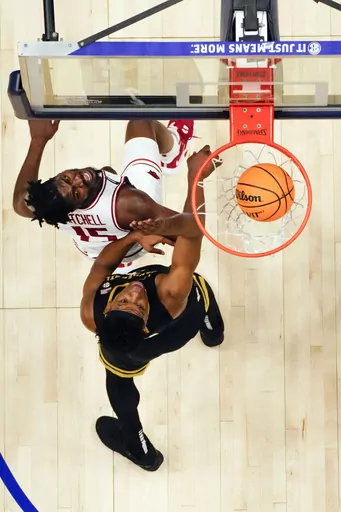 Vanderbilt forward Ven-Allen Lubin (2) scores as Arkansas forward Makhi Mitchell (15) defends during the first half of a NCAA college basketball game at the Southeastern Conference, Wednesday, March 13, 2024, in Nashville, Tenn. (AP Photo/John Bazemore)