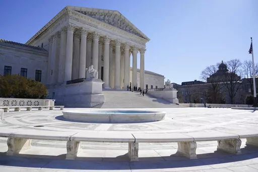 People stand on the steps of the U.S. Supreme Court, Feb.11, 2022, in Washington.  (AP Photo/Mariam Zuhaib, File)