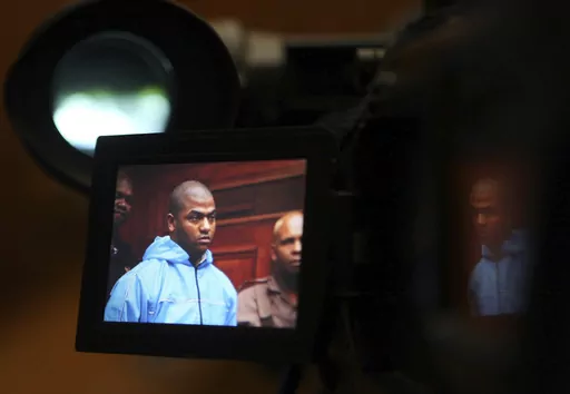 Thabo Bester is seen on a TV camera screen in the Western Cape High Court, in Cape Town, South Africa Thursday, May 3, 2012, where he appeared in connection with murder. The South African convicted murderer who faked his death to escape from prison has been arrested in Tanzania following a two-week manhunt, police have announced. South African officials are going to Tanzania Sunday April 9, 2023, to begin to extradite Thabo Bester. (AP Photo/Nardus Engelbrecht)