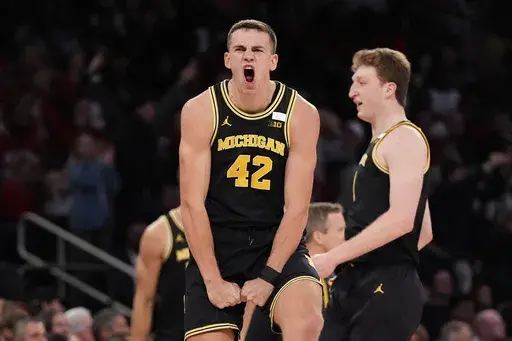 Michigan forward Will Tschetter (42) reacts during the first half of an NCAA college basketball game against Arkansas, Tuesday, Dec. 10, 2024, in New York. (AP Photo/Julia Demaree Nikhinson)