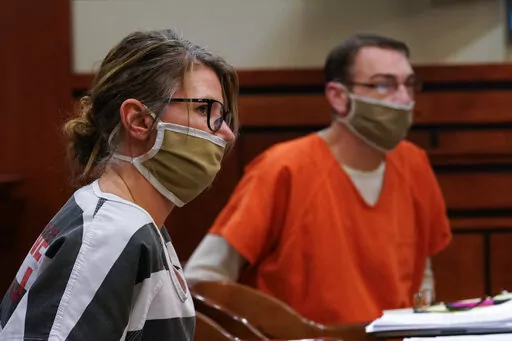 Jennifer and James Crumbley, the parents of Ethan Crumbley, a teenager accused of killing four students in a shooting at Oxford High School, appear in court for a preliminary examination on involuntary manslaughter charges in Rochester Hills, Mich., Tuesday, Feb. 8, 2022. (AP Photo/Paul Sancya)