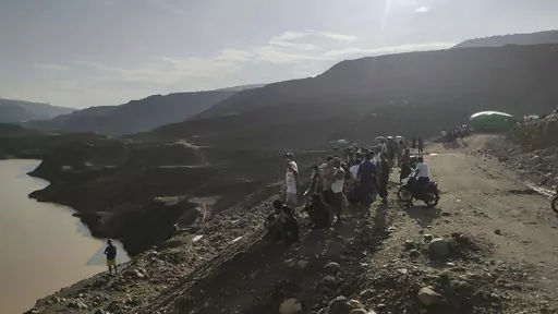 Miners, rescuers and local residents look at the jade mine site where a landslide accident took place in Hpakant township, Kachin state, Myanmar Sunday, Aug. 13, 2023. A landslide at the jade mine left scores of people missing, and a search and rescue operation was underway on Monday, a rescue official said. (AP Photo)