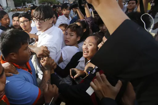 Police officers drag student Chonthicha Jangrew, bottom center, during a protest marking the first anniversary of the military coup, in Bangkok, Thailand, May 22, 2015. Three years ago, tens of thousands of mostly young people in Thailand took to the streets in heated demonstrations seeking democratic reforms. Now, with a general election coming in three weeks, leaders of the country’s progressive movement are hoping to channel the same radical spirit for change though the ballot box. (AP Phot