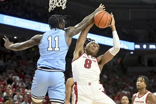 Arkansas forward Chandler Lawson (8) and Old Dominion forward Dani Pounds (11) fight for a rebound during the first half of an NCAA college basketball game Monday, Nov. 13, 2023, in Fayetteville, Ark. (AP Photo/Michael Woods)