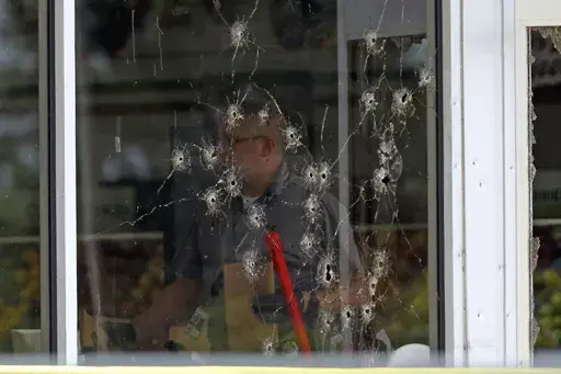 Damage can be seen to a front window as law enforcement officers work the scene of a shooting at the Mad Butcher grocery store in Fordyce, Ark., June 21, 2024. (Colin Murphey/Arkansas Democrat-Gazette via AP, File)