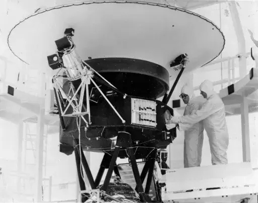 This photo provided by NASA shows the "Sounds of Earth" record being mounted on the Voyager 2 spacecraft in the Safe-1 Building at the Kennedy Space Center, Fla. Aug. 4, 1977. (AP Photo/NASA, File)
