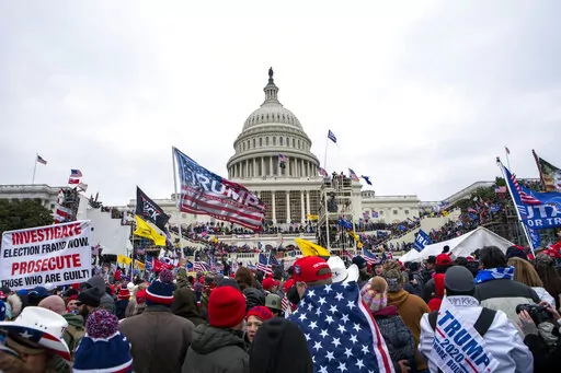 Rioters loyal to President Donald Trump rally at the U.S. Capitol in Washington on Jan. 6, 2021. A trial starts this week for a former Virginia police officer charged with storming the U.S. Capitol with a fellow officer who has agreed to cooperate with federal prosecutors. Jury selection is scheduled to begin Monday, April 4, 2022, for the case against former Rocky Mount police officer Thomas Robertson. (AP Photo/Jose Luis Magana, File)