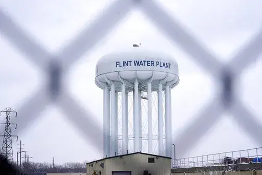 The Flint water plant tower is seen on Jan. 6, 2022, in Flint, Mich. A judge declared a mistrial Thursday, Aug. 11, after jurors said they couldn't reach a verdict in a dispute over whether two engineering firms should bear some responsibility for Flint's lead-contaminated water. Four families accused Veolia North America and Lockwood, Andrews & Newman, known as LAN, of not doing enough to get Flint to treat the highly corrosive water or to urge a return to a regional water supplier. (AP Photo/C