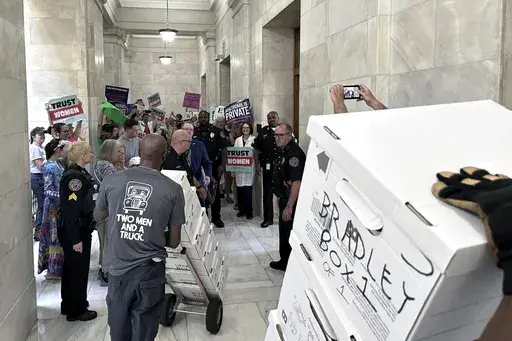 Boxes containing signatures supporting a proposed ballot measure to scale back Arkansas' abortion ban are delivered to a room in the state Capitol, July 5, 2024, in Little Rock, Ark. The signatures collected by volunteers for an Arkansas abortion-rights measure would fall short of the number needed to qualify for ballot if those are the only ones counted, according to an initial tally from election officials filed with the state Supreme Court on Thursday, July 25. (AP Photo/Andrew DeMillo, File)