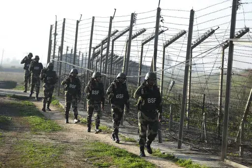 FILE- Indian Border Security Force (BSF) soldiers patrol near the India-Pakistan border fencing at Suchet Garh in Ranbir Singh Pura, Jammu and Kashmir, India, Jan. 23, 2020. For decades, India has tried to thwart Pakistan in a protracted dispute over Kashmir. But in the last two years, policy makers in New Delhi have been increasingly turning their focus to Beijing, in a significant shift in India's foreign policy as the nation celebrates 75 years of independence. (AP Photo/Channi Anand, File)