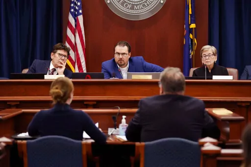 Members of the Michigan Board of State Canvassers, from left, Richard Houskamp, Anthony Daunt and Mary Ellen Gurewitz listen to attorneys Olivia Flower and Steve Liedel during a hearing, Wednesday, Aug. 31, 2022, in Lansing, Mich. Republican-dominated courts and legislatures have been pushing back against citizen-led ballot initiatives to keep them off the ballot, in what critics say is a partisan attack on direct democracy. (AP Photo/Carlos Osorio, File)