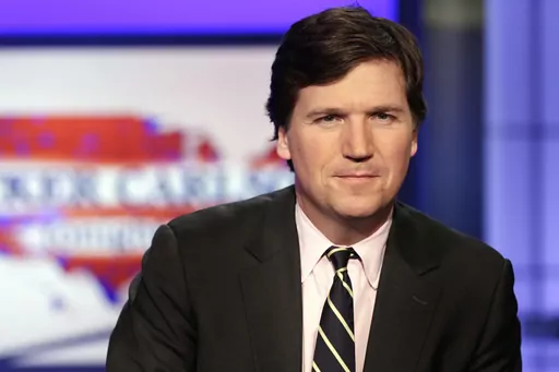Tucker Carlson, host of "Tucker Carlson Tonight," poses for photos in a Fox News Channel studio on March 2, 2017, in New York. A racist text message from Tucker Carlson is what helped drive the commentator's ouster from Fox News, The New York Times reports. The Times says that in a text uncovered as part of a recent defamation lawsuit, the former Fox host lamented how supporters of former President Donald Trump ganged up to beat a protester. “It's not how white men fight,” Carlson wrote. (AP
