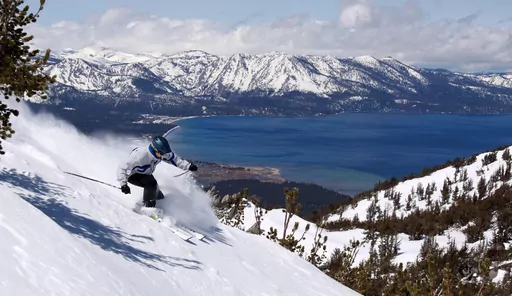 FILE — A skier kicks up some powder at Heavenly Ski Resort, in South Lake Tahoe, Calif., April 14, 2010. A snowboarder spent 15 hours trapped overnight Thursday, Jan. 26, 2024, inside a ski lift gondola amid freezing temperatures at the Lake Tahoe resort, according to officials and media reports. (AP Photo/Dino Vournas, File)