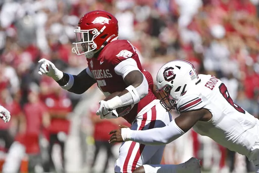 Arkansas running back Raheim Sanders (5) runs the ball past South Carolina defensive back Gilber Edmond (8) during the first half of an NCAA college football game Saturday, Sept. 10, 2022, in Fayetteville, Ark. (AP Photo/Michael Woods)