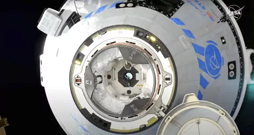 This image from NASA TV shows the Boeing Starliner preparing to dock at the International Space Station, Friday, May 20, 2022. Boeing's astronaut capsule has arrived at the International Space Station in a critical repeat test flight. Only a test dummy was aboard the capsule for Friday's docking, a huge achievement for Boeing after years of false starts. (NASA via AP)