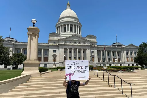 A demonstrator holds a sign outside the Arkansas Capitol in Little Rock, Ark., June 24, 2022, protesting the U.S. Supreme Court's decision overturning Roe v. Wade. Arkansas' attorney general on Tuesday, Jan. 23, 2024, approved the wording of a proposed ballot measure that would scale back the state's abortion ban, clearing the way for supporters to begin gathering enough signatures to qualify for the November election. (AP Photo/Andrew DeMillo, File)
