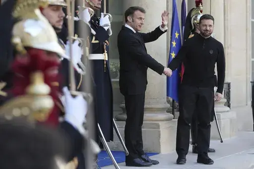 French President Emmanuel Macron, left, welcomes Ukrainian President Volodymyr Zelenskyy before their meeting to prepare Thursday's gathering of the so-called "coalition of the willing" nations that are allies of Ukraine, Wednesday, March 26, 2025 at the Elysee Palace in Paris. (AP Photo/Thibault Camus)
