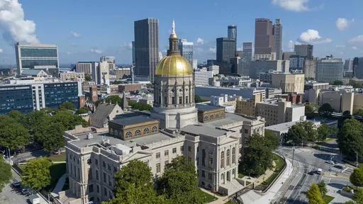 The gold dome of the Georgia Capitol gleams in the sun, Aug. 27, 2022, in front of the skyline of downtown Atlanta. Legislation that would ban some citizens of China from owning farmland in Georgia is advancing at the state Capitol despite criticism that it promotes xenophobia and could face legal hurdles. (AP Photo/Steve Helber, File)