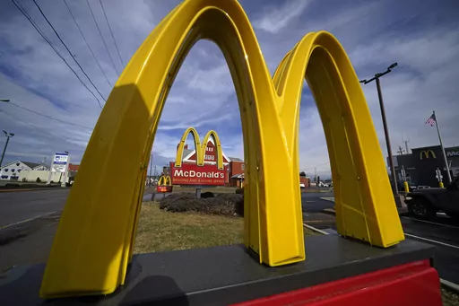 McDonald's restaurant signs are shown in in East Palestine, Ohio, Feb. 9, 2023. Krispy Kreme stock jumped Tuesday, March 26, 2024, after it announced a deal where McDonald’s restaurants will sell its doughnuts across the country.(AP Photo/Gene J. Puskar, File)