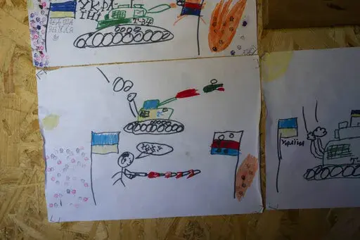Drawings made by Ukrainian children decorate a sleeping area in a Ukrainian trench near the front lines in the Donetsk region, eastern Ukraine, Wednesday, June 8, 2022. (AP Photo/Bernat Armangue)