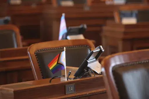 A small flag promoting LGBTQ+ rights sits on the desk of state Rep. Jo Ella Hoye, D-Lenexa, in the House chamber as Republicans prepare to push for a ban on gender-affirming care for transgender minors, Thursday, Jan. 16, 2025, in the Statehouse in Topeka, Kan. (AP Photo/John Hanna)