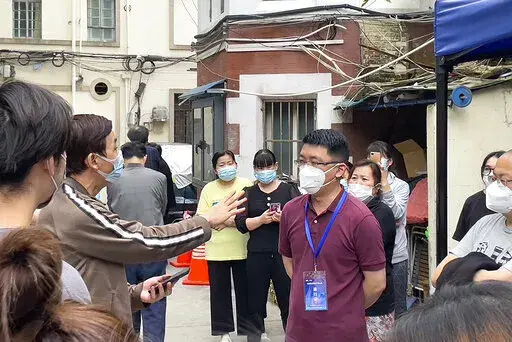 Residents confront a representative about opening up of their compound in Jingan district in Shanghai on May 25, 2022. Residents in China's largest city of Shanghai have become bolder in demanding the lifting or easing of coronavirus restrictions that have left millions locked up in their compounds for almost two months. (AP Photo)