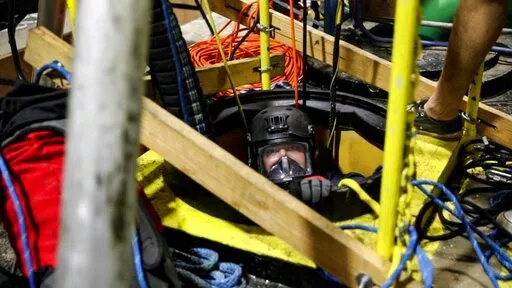 In this Dec. 11, 2021, photo provided by the U.S. Navy, Mobile Diving Salvage Unit One performs inspection and sampling of a water well near Pearl Harbor, Hawaii, where U.S. Navy divers are trying to remove fuel from a water shaft at Red Hill. The Navy is scrambling to contain what one lawmaker has called a "crisis of astronomical proportions" after jet fuel leaked from an 80-year-old Hawaii tank farm, seeped into a drinking water well and polluted the water streaming out of faucets in Pearl Har