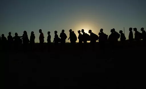 Migrants who crossed the Rio Grande and entered the U.S. from Mexico are lined up for processing by U.S. Customs and Border Protection, Sept. 23, 2023, in Eagle Pass, Texas. Texas began flying migrants from the U.S.-Mexico border to Chicago on Wednesday, Dec. 20, a week after the city took a tougher stance on the buses that Republican Gov. Greg Abbott has been sending north since last year. (AP Photo/Eric Gay, File)