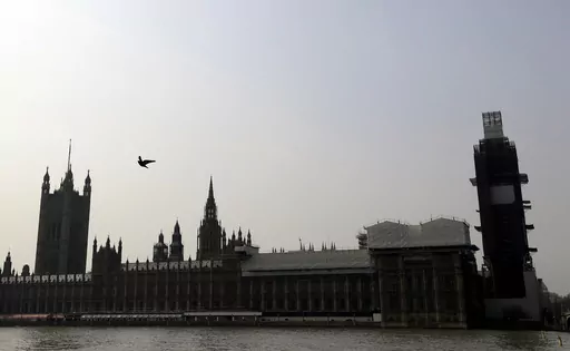 Britain's Houses of Parliament, covered in hoarding and scaffolding as it undergoes restoration work to repair the crumbling building, in London, Wednesday, April 17, 2019. British lawmakers are warning that the country's Parliament building is at “real and rising” risk of destruction. The House of Commons Public Accounts Committee said Parliament is “leaking, dropping masonry and at constant risk of fire,” as well as riddled with asbestos. The committee said Wednesday, May 17, 2023 that