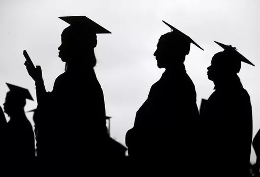 New graduates line up before the start of a community college commencement in East Rutherford, N.J., May 17, 2018. A federal judge in St. Louis on Thursday, Oct. 20, 2022, dismissed an effort by six Republican-led states to block the Biden administration's plan to forgive student loan debt for tens of millions of Americans. (AP Photo/Seth Wenig, File)