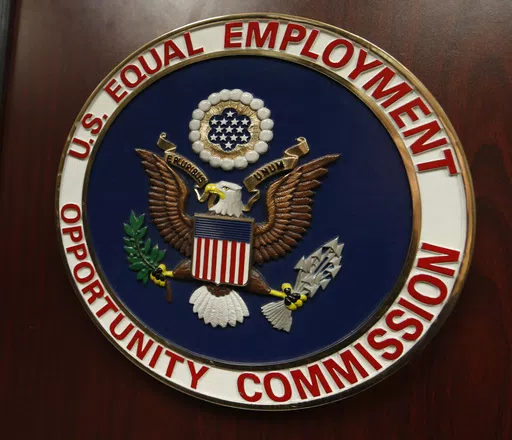 The emblem of the U.S. Equal Employment Opportunity Commission is shown on a podium in Vail, Colo., Tuesday, Feb. 16, 2016, in Denver. Pregnant workers have the right to a wide range of accommodations under new federal regulations for implementing the Pregnant Workers Fairness Act. The regulations take an expansive view of conditions related to pregnancy, from fertility treatments to abortion and post-childbirth complications. (AP Photo/David Zalubowski, File)