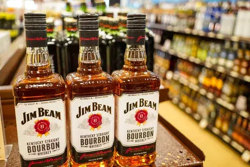 Shelves display bottles of bourbons for sale at a Pennsylvania fine wine and spirits store, Saturday, Jan. 22, 2022, in Harmony, Pa. Jim Beam plans to ramp up bourbon production at its largest Kentucky distillery to meet growing global demand in a more than $400 million expansion to be powered by renewable energy. The project will increase capacity by 50% at the Beam plant in Boston, Kentucky, while reducing greenhouse gas emissions by the same percentage, Beam Suntory said Wednesday, Sept. 14. 