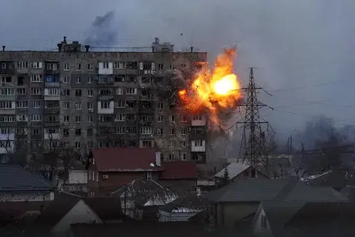 Fire erupts at an apartment building in Mariupol, Ukraine, after a Russian tank opens fire on March 11, 2022. (AP Photo/Evgeniy Maloletka, File)