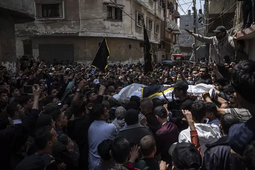 Mourners carry the bodies of Khalil Bahtini, the Islamic Jihad militant group's commander for the northern Gaza Strip, his wife and son, who were killed in an Israeli airstrike at their family home, during their funeral, in Gaza City, Tuesday, May 9, 2023. Bahtini was among three senior Islamic Jihad commanders killed in targeted airstrikes early Tuesday. Palestinian health officials said at least 10 others were killed, including wives of two of the militants, several of their children and other