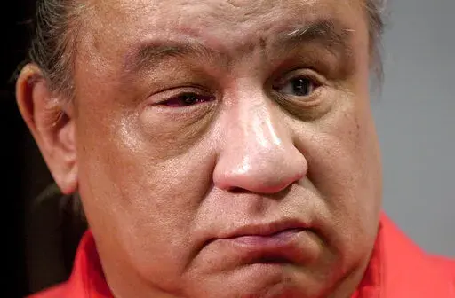 Raymond Washburn appears before reporters at morning news conference at the Oklahoma State Capitol in Oklahoma City, in this undated photo. Washburn, a blind man who was credited with helping rescue five people from the rubble of the Alfred P. Murrah federal building following the 1995 Oklahoma City bombing, died Jan. 16, 2022, at his home in Oklahoma City. He was 75. (Jim Beckel/The Oklahoman via AP)