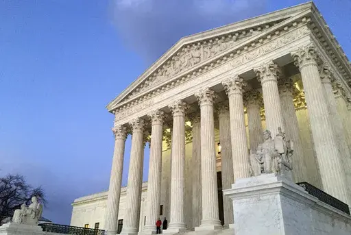 People stand on the steps of the Supreme Court at sunset in Washington, Feb. 13, 2016. (AP Photo/Jon Elswick, File)