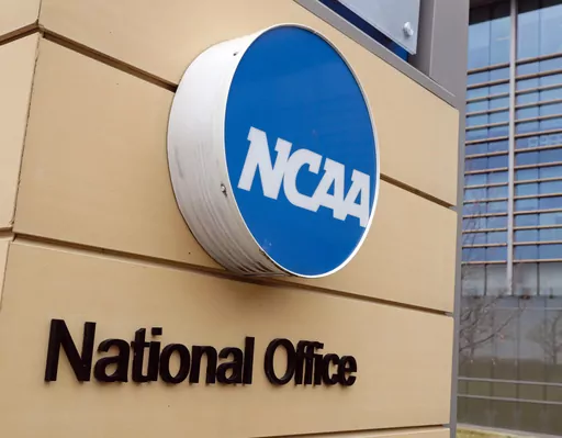 Signage at the headquarters of the NCAA is viewed in Indianapolis, March 12, 2020. Lawmakers in Arkansas, Texas and elsewhere are working to remove barriers between college athletes trying to cash in on their fame and the schools for which they play. The latest legislative maneuvering paves the way for schools and their fundraising arms to be directly involved in securing and paying for their athletes’ name, image and likeness deals. These amended laws are also trying to shield athletic depart