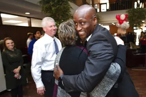 Charles Robinson is congratulated by associates after being hired as the chancellor of the University of Arkansas during an impromptu reception at the university's administration building on Wednesday, Nov. 16, 2022, in Fayetteville, Ariz. Robinson became the first Black person to lead the flagship campus. (Andy Shupe/The Northwest Arkansas Democrat-Gazette via AP)