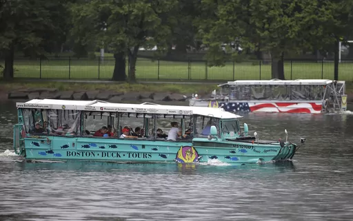 Duck boats, replicas of World War II-era amphibious vehicles, and a popular tourist attraction, make their way along the Charles River between Boston and Cambridge, Mass., Sunday, July 22, 2018. Five years after 17 people died when a tourist vessel known as a duck boat sank on a Missouri lake, the U.S. Coast Guard on Monday, Sept. 11, 2023 issued new rules for amphibious World War II vessels retrofitted for tourists. (AP Photo/Steven Senne, File)