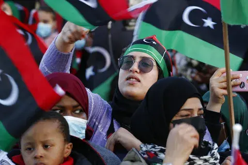 Libyans celebrate February Revolution Day in Martyrs' Square in Tripoli, Libya, Feb. 18, 2022. Two separate governments are once again vying for power in Libya. It's the latest setback, reversing tentative steps toward unity in the past year, including promised elections that never materialized. Clashes in the country's capital of Tripoli last month underscored the fragility of Libya's relative peace that has prevailed for more than a year. (AP Photo/Yousef Murad, File)
