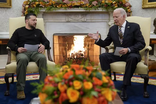 President Joe Biden reaches out to shake hands with Ukrainian President Volodymyr Zelenskyy as they meet in the Oval Office of the White House, Tuesday, Dec. 12, 2023, in Washington. The White House says funding for Ukraine has run out and it has been increasing pressure on Congress to pass stalled legislation to support the war against Russia. On Tuesday, however, Biden touted a new military aid package worth $200 million for Ukraine. That may seem contradictory, but it’s due to the complex p