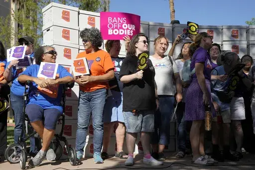 Arizona abortion-rights supporters gather for a news conference prior to delivering over 800,000 petition signatures to the capitol to get abortion rights on the November general election ballot Wednesday, July 3, 2024, in Phoenix. Abortion access ballot measures are the center of a new wave of legal and procedural questions across the U.S., including Arizona, where there's a dispute over language to describe a measure. (AP Photo/Ross D. Franklin, File)