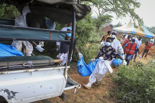 Police and local residents load the exhumed bodies of victims of a religious cult into the back of a truck in the village of Shakahola, near the coastal city of Malindi, in southeastern Kenya Sunday, April 23, 2023. Dozens of bodies have been discovered so far in shallow graves in a forest near land owned by a pastor Paul Makenzi in coastal Kenya who was arrested for telling his followers to fast to death. (AP Photo)