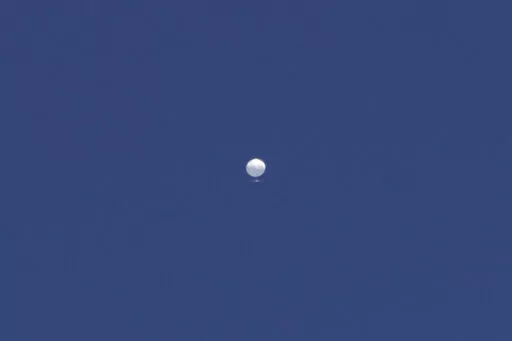 A balloon floats over Columbia, Mo., on Friday, Feb. 3, 2023. A huge, high-altitude Chinese balloon sailed across the U.S. on Friday, drawing severe Pentagon accusations of spying despite China's firm denials. (Anna Griffin/Missourian via AP)