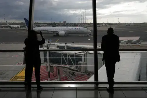 People look at a United Airlines flight leaving for Newark, NJ, at Fiumicino's Leonardo Da Vinci airport, near Rome, Monday, Nov. 8, 2021.    Experience may be the best teacher when traveling. (AP Photo/Alessandra Tarantino, File)