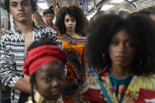 Models wear outfits designed by students from Afro-Brazilian communities at a subway station as part of Black Consciousness Awareness Month, in Sao Paulo, Brazil, Nov. 19, 2021. In Brazil, more than half the population self-identifies as Black or biracial. (AP Photo/Andre Penner, File)